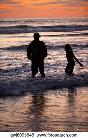 Father and his daughter playing in the water at the beach View Large Photo Image Stock Photo - Father and his daughter playing in the water at the beach. Fotosearch