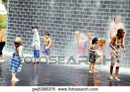 Group of children playing in water View Large Photo Image Stock Photography - Group of children playing in water. Fotosearch