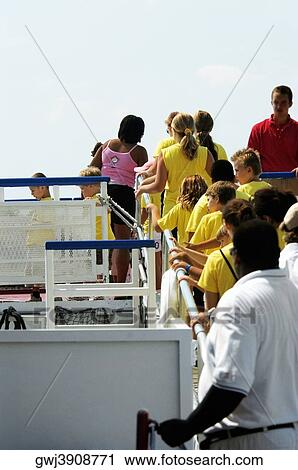 Group of people boarding a sightseeing boat View Large Photo Image Stock Image - Group of people boarding a sightseeing boat. Fotosearch