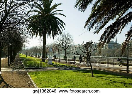Group of people on the walkway by the river, Spain View Large Photo Image Stock Photograph - Group of people on the walkway by the river, Spain. Fotosearch