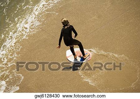 High angle view of a boogie boarder on the beach View Large Photo Image Stock Image - High angle view of a boogie boarder on the beach. Fotosearch