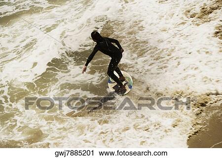 Stock Image - High angle view of a boogie boarder on the beach. Fotosearch