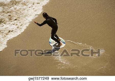 High angle view of a boogie boarder on the beach View Large Photo Image Stock Photo - High angle view of a boogie boarder on the beach. Fotosearch