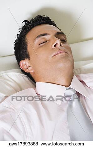 High angle view of a businessman sleeping in an armchair View Large Photo Image Stock Photo - High angle view of a businessman sleeping in an armchair. Fotosearch
