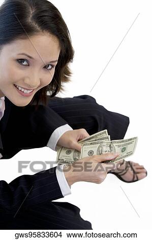 High angle view of a businesswoman holding American paper currency View Large Photo Image Picture - High angle view of a businesswoman holding American paper currency. Fotosearch