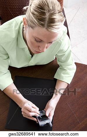 High angle view of a businesswoman using a mobile phone View Large Photo Image Stock Image - High angle view of a businesswoman using a mobile phone. Fotosearch