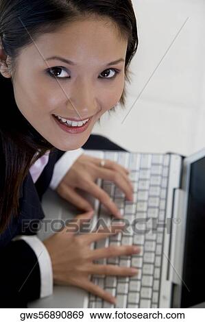 High angle view of a businesswoman using a laptop View Large Photo Image Stock Photo - High angle view of a businesswoman using a laptop. Fotosearch