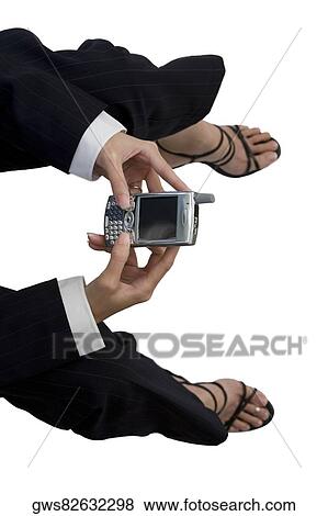 High angle view of a businesswoman holding a mobile phone View Large Photo Image Stock Photo - High angle view of a businesswoman holding a mobile phone. Fotosearch