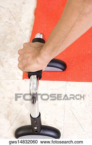High angle view of a man's hand holding exercising equipment View Large Photo Image Stock Image - High angle view of a man's hand holding exercising equipment. Fotosearch