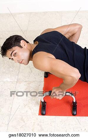 High angle view of a mid adult man doing push-ups View Large Photo Image Stock Image - High angle view of a mid adult man doing push-ups. Fotosearch