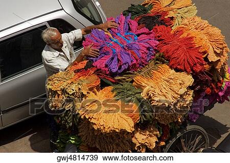 High angle view of a senior man loading bundle of clothes on a cart View Large Photo Image Stock Photo - High angle view of a senior man loading bundle of clothes on a cart. Fotosearch