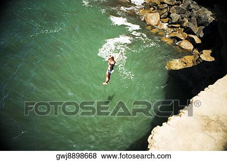 High angle view of a woman jumping into an inlet, Coronado Reefs, San Diego, California, USA View Large Photo Image Stock Photo - High angle view of a woman jumping into an inlet, Coronado Reefs, San Diego, California, USA. Fotosearch