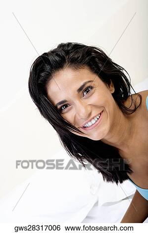 High angle view of a young woman smiling View Large Photo Image Stock Photograph - High angle view of a young woman smiling. Fotosearch