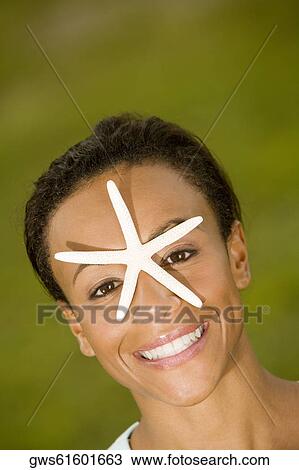 High angle view of a young woman with a star fish on her face View Large Photo Image Stock Image - High angle view of a young woman with a star fish on her face. Fotosearch