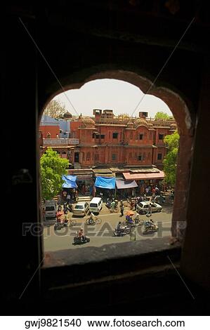 Stock Image - High angle view of the street seen from a arched window, City Palace Jaipur, Rajasthan, India. Fotosearch