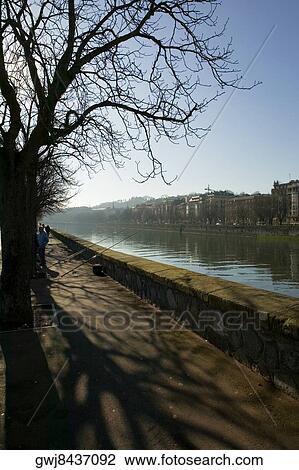 Stock Image - High angle view of two people fishing in a river, Spain. Fotosearch