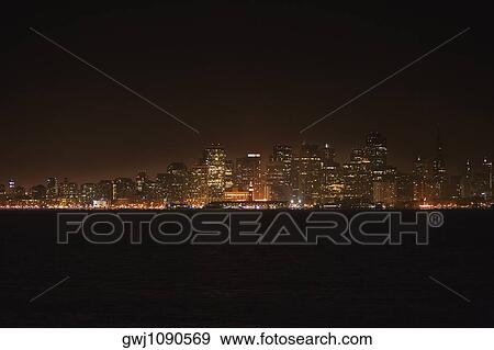 Stock Photo - Illuminated buildings at waterfront, California, USA. Fotosearch