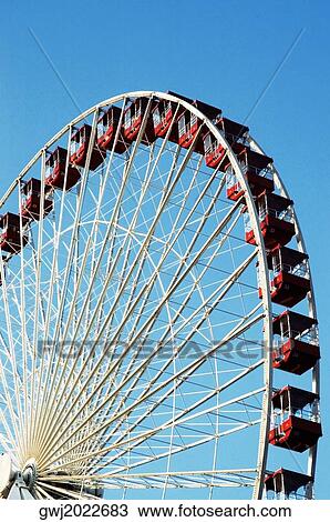 Low angle view of a ferris wheel in an amusement park View Large Photo Image Stock Image - Low angle view of a ferris wheel in an amusement park. Fotosearch