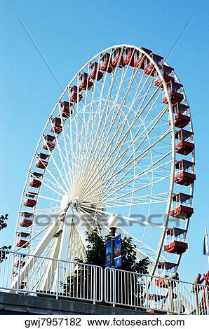 Stock Image - Low angle view of a ferris wheel in an amusement park. Fotosearch