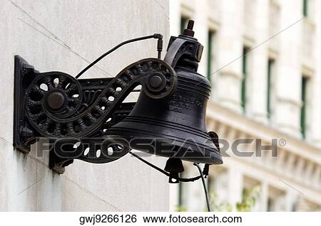 Low angle view of a metal bell mounted on a building wall View Large Photo Image Stock Photograph - Low angle view of a metal bell mounted on a building wall. Fotosearch