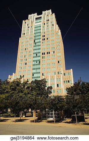 Low angle view of an office building at a road side View Large Photo Image Picture - Low angle view of an office building at a road side. Fotosearch