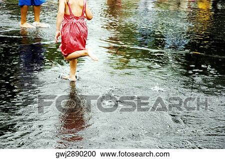 Low section view of two children playing in water View Large Photo Image Stock Image - Low section view of two children playing in water. Fotosearch