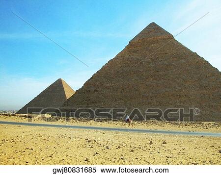 Man on a camel in front of the pyramids, Giza Pyramids, Giza, Cairo, Egypt View Large Photo Image Stock Photography - Man on a camel in front of the pyramids, Giza Pyramids, Giza, Cairo, Egypt. Fotosearch