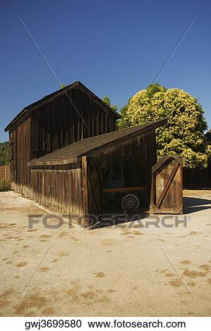 Stock Image - Open door of an old wooden house. Fotosearch