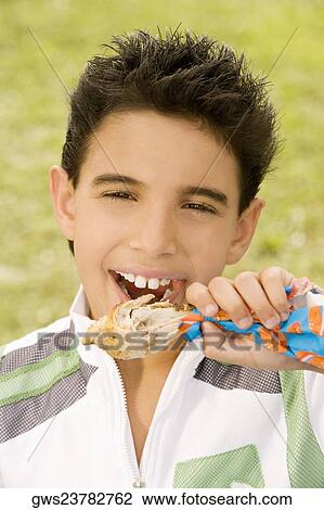 Portrait of a boy eating a chicken drumstick View Large Photo Image Stock Image - Portrait of a boy eating a chicken drumstick. Fotosearch