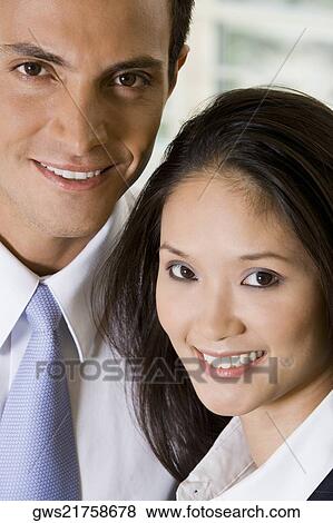 Stock Photo - Portrait of a businessman and a businesswoman smiling. Fotosearch