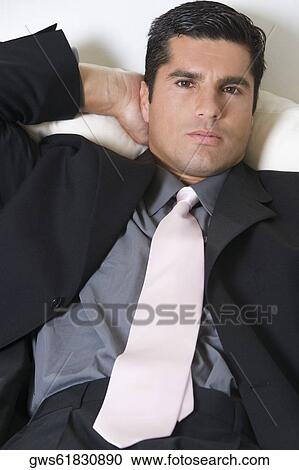 Portrait of a businessman resting on a couch View Large Photo Image Stock Image - Portrait of a businessman resting on a couch. Fotosearch