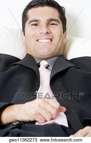 Stock Image - Portrait of a businessman smiling. Fotosearch