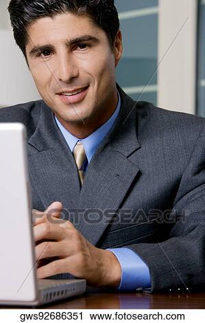 Portrait of a businessman smiling View Large Photo Image Stock Image - Portrait of a businessman smiling. Fotosearch