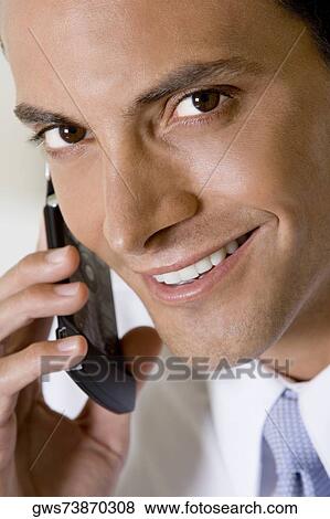Portrait of a businessman talking on a mobile phone View Large Photo Image Stock Photo - Portrait of a businessman talking on a mobile phone. Fotosearch
