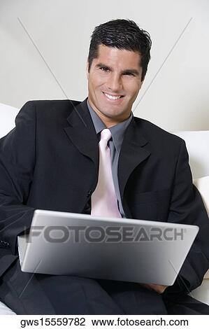 Portrait of a businessman using a laptop View Large Photo Image Stock Image - Portrait of a businessman using a laptop. Fotosearch
