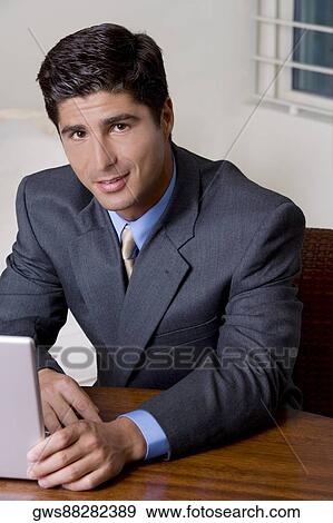 Portrait of a businessman using a laptop View Large Photo Image Stock Photo - Portrait of a businessman using a laptop. Fotosearch