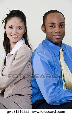 Portrait of a businesswoman and a businessman smiling View Large Photo Image Stock Image - Portrait of a businesswoman and a businessman smiling. Fotosearch