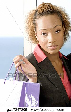 Portrait of a businesswoman holding a shopping bag View Large Photo Image Stock Image - Portrait of a businesswoman holding a shopping bag. Fotosearch