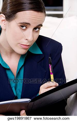 Portrait of a businesswoman holding a file View Large Photo Image Stock Photo - Portrait of a businesswoman holding a file. Fotosearch