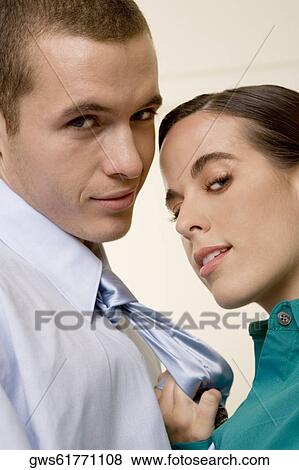Portrait of a businesswoman holding a businessman by his tie View Large Photo Image Stock Photo - Portrait of a businesswoman holding a businessman by his tie. Fotosearch