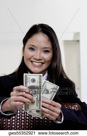 Portrait of a businesswoman holding one hundred dollar bills View Large Photo Image Stock Image - Portrait of a businesswoman holding one hundred dollar bills. Fotosearch