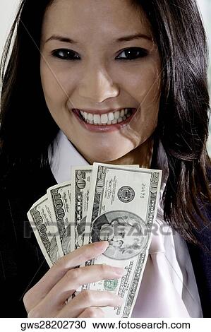 Portrait of a businesswoman holding American dollar bills View Large Photo Image Stock Image - Portrait of a businesswoman holding American dollar bills. Fotosearch