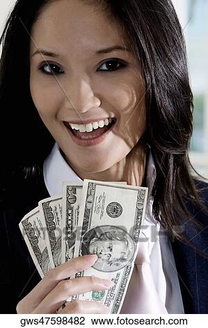 Portrait of a businesswoman holding American dollar bills View Large Photo Image Stock Image - Portrait of a businesswoman holding American dollar bills. Fotosearch