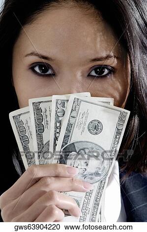 Portrait of a businesswoman holding American dollar bills View Large Photo Image Stock Image - Portrait of a businesswoman holding American dollar bills. Fotosearch