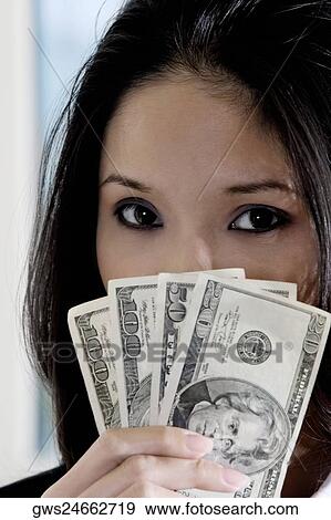 Portrait of a businesswoman holding American dollar bills View Large Photo Image Stock Photo - Portrait of a businesswoman holding American dollar bills. Fotosearch