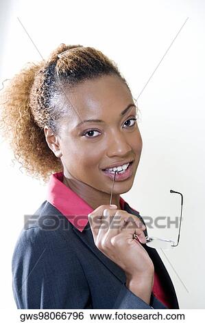 Stock Photograph - Portrait of a businesswoman holding eyeglasses. Fotosearch