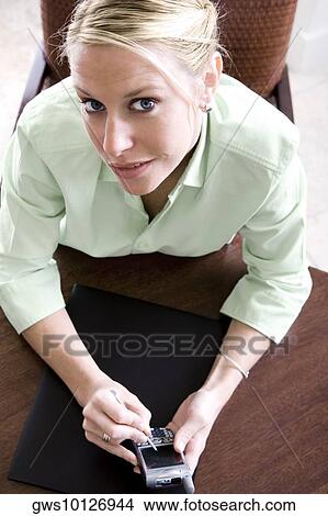 Picture - Portrait of a businesswoman using a mobile phone. Fotosearch