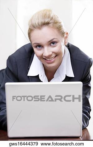 Stock Photo - Portrait of a businesswoman using a laptop. Fotosearch