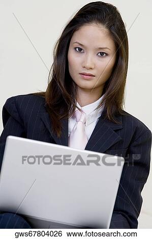 Stock Photograph - Portrait of a businesswoman using a laptop. Fotosearch