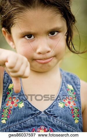 Portrait of a girl showing thumbs down View Large Photo Image Stock Photo - Portrait of a girl showing thumbs down. Fotosearch